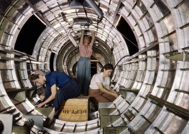 Women workers install fixtures and assemblies to a tail fuselage section of a B-17F bomber at the Douglas Aircraft Company, Long Beach, California. Photographed in October, 1942