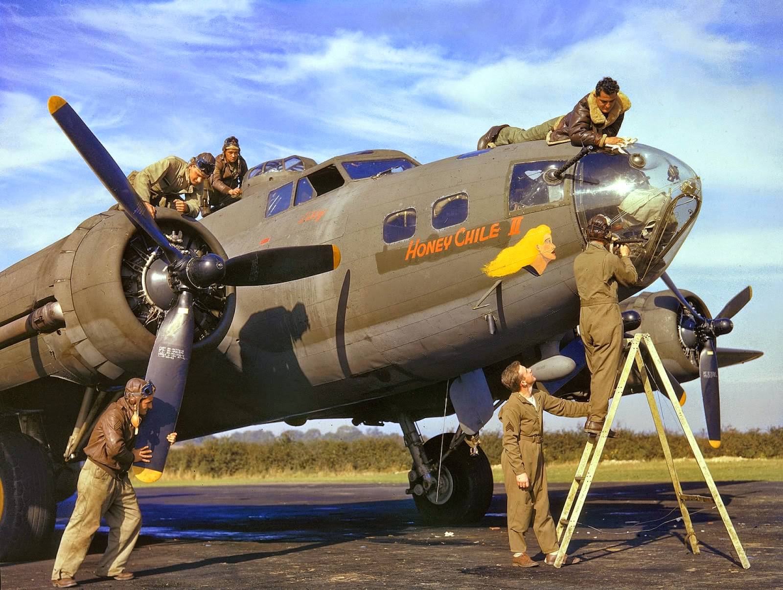 Members of the flight and ground crews of a B-17 bomber named 'Honey Chile II' make adjustments to their plane prior to a mission, Polebrook, Northamptonshire, England, fall 1942.