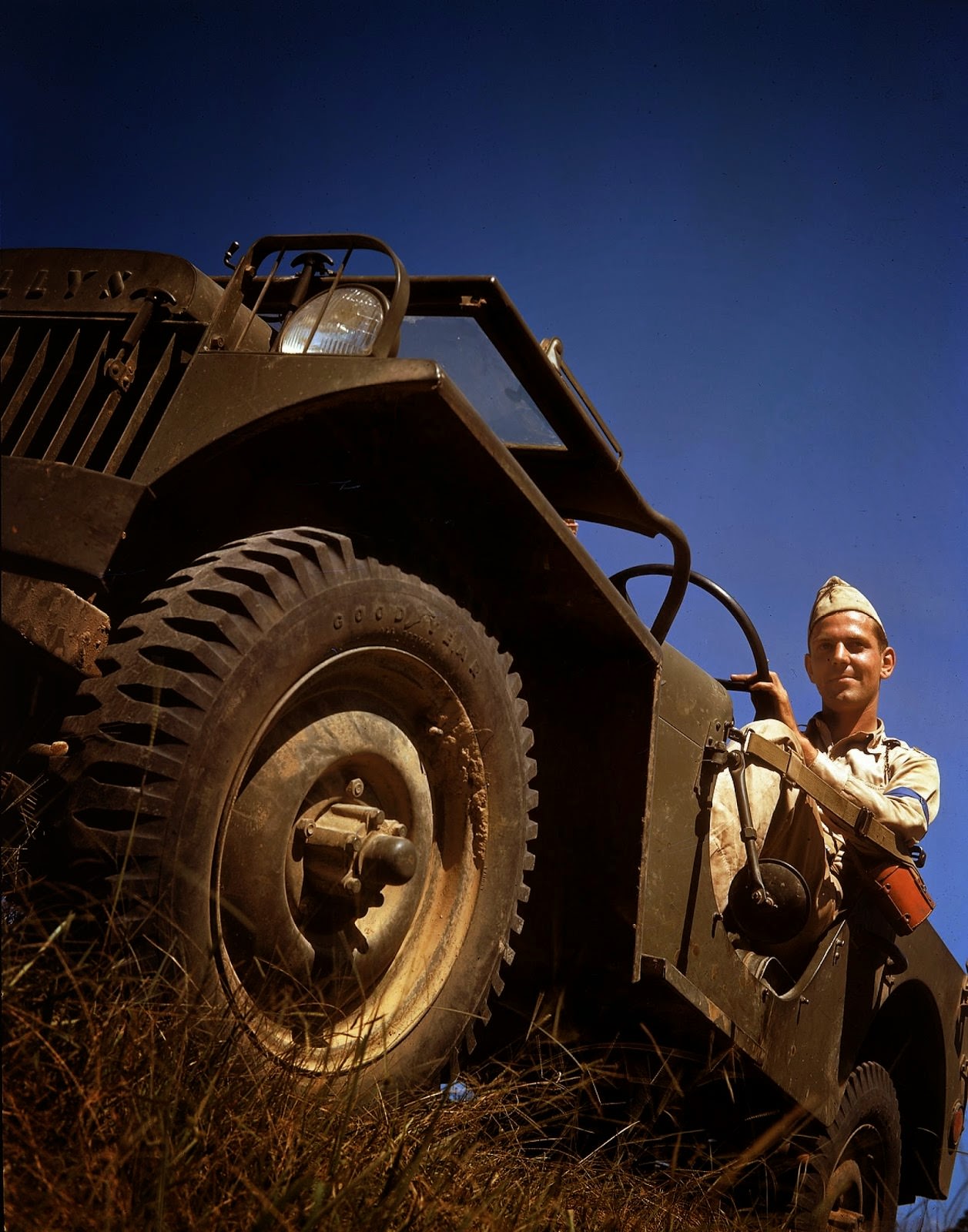 An American soldier sits behind the wheel of a Willys MB jeep, shortly before the United States joined World War II, 1941.