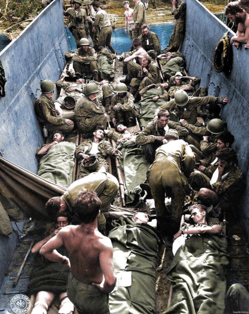 Wounded troops lying on stretchers aboard a lighter in Munda Point, New Georgia. There were more than 36 million casualties during the War in the Pacific.