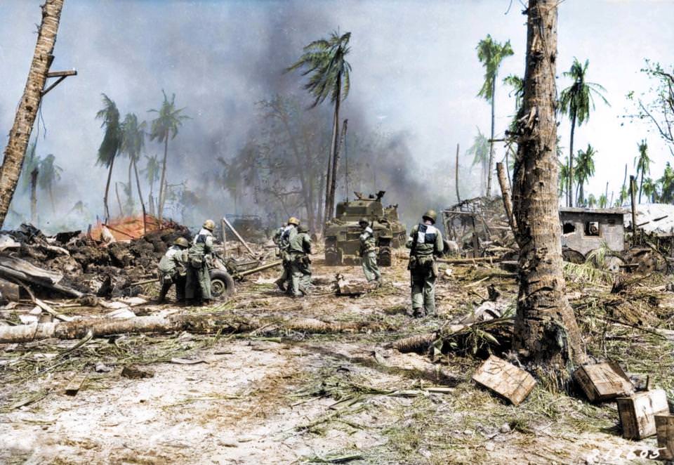 Soldiers make their way across the barren landscape in Kwajalein, Marshall Islands, 1944.