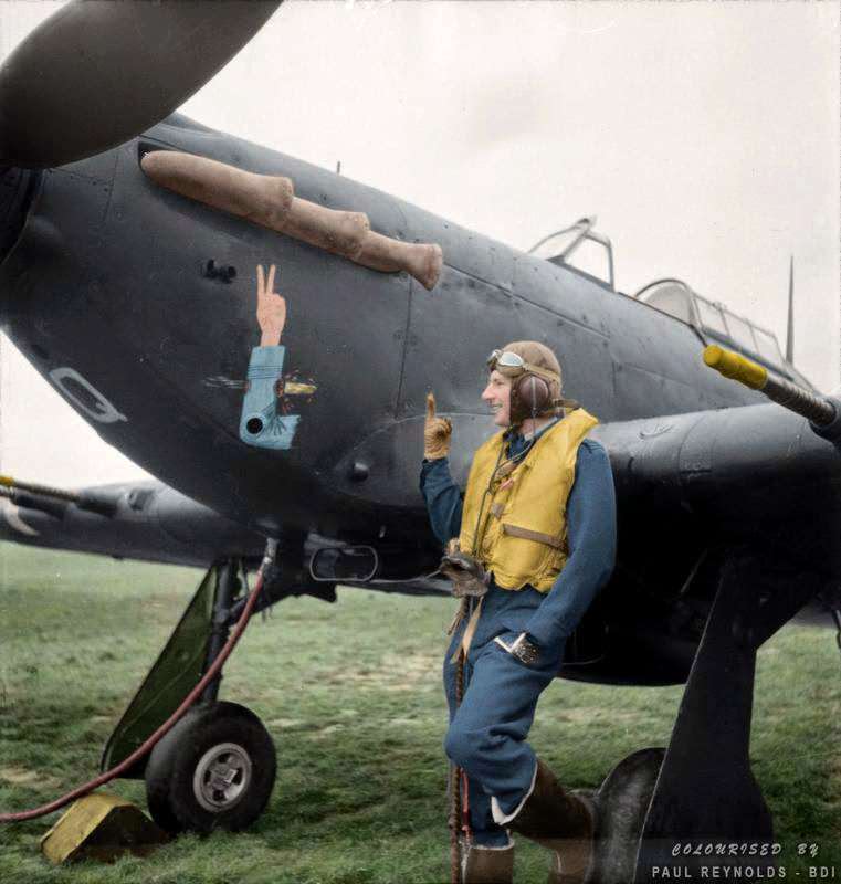 Squadron Leader J.A.F. MacLachlan, the one-armed Commanding Officer of No 1 Squadron RAF, standing beside his all-black Hawker Hurricane Mark IIC night fighter, 'JX-Q', at Tangmere in West Sussex, England