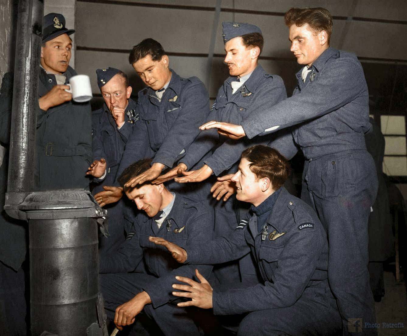 The crew of Avro Lancaster "C for Charlie" of No. 44 (Rhodesia) Squadron RAF, try to warm themselves in their Nissen hut quarters at Dunholme Lodge, Lincolnshire, England, after returning from a raid on Stuttgart, 2nd of March 1944