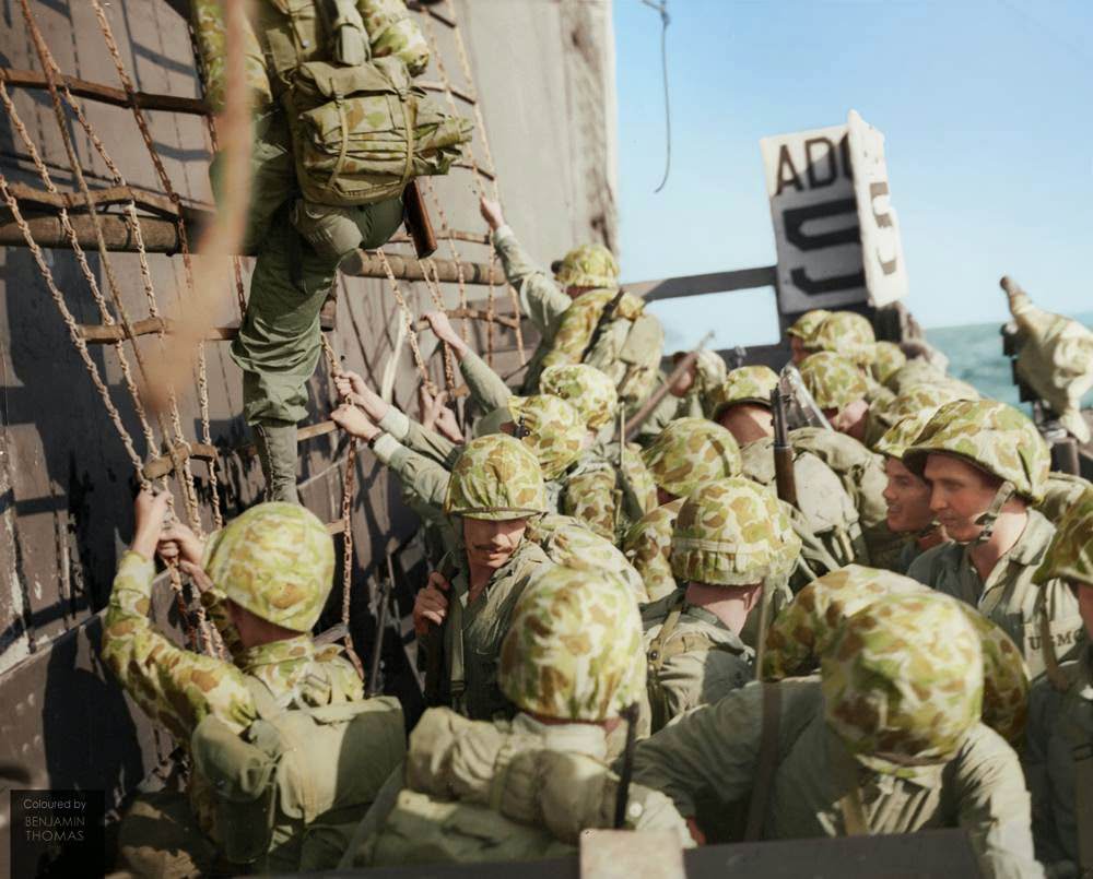 United States Marines climbing down the nets into landing craft during the Battle of Peleliu, September-November 1944.