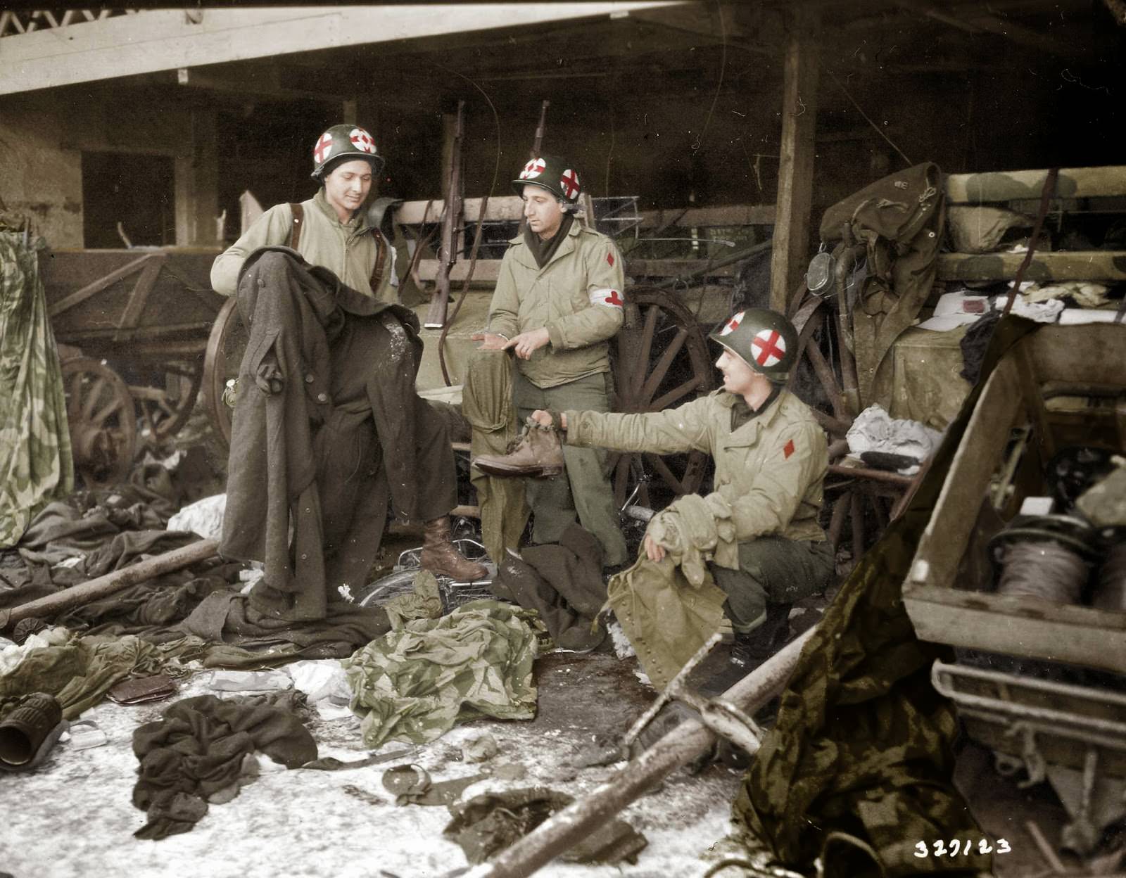 Medics of the US. 5th Infantry Division examining GI clothing found with German-captured equipment after the liberation of the area, near Diekirch in Luxembourg on the 20th of January 1945
