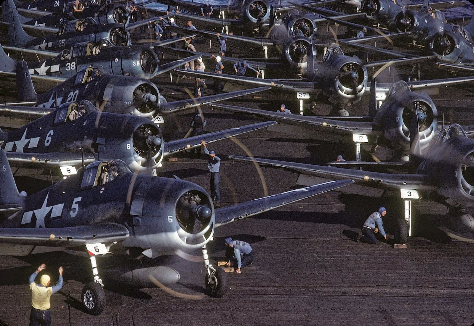 The flight deck crew prepares planes for launch from the USS Lexington (CV-16), en route near New Guinea, early April, 1944.