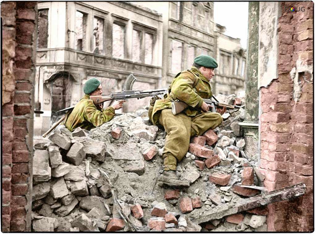 Royal Marines from 45 (RM) Commando, 1st Commando Brigade on the look-out for snipers among the ruins in Osnabrück, Lower Saxony, Germany. 4th of April 1945