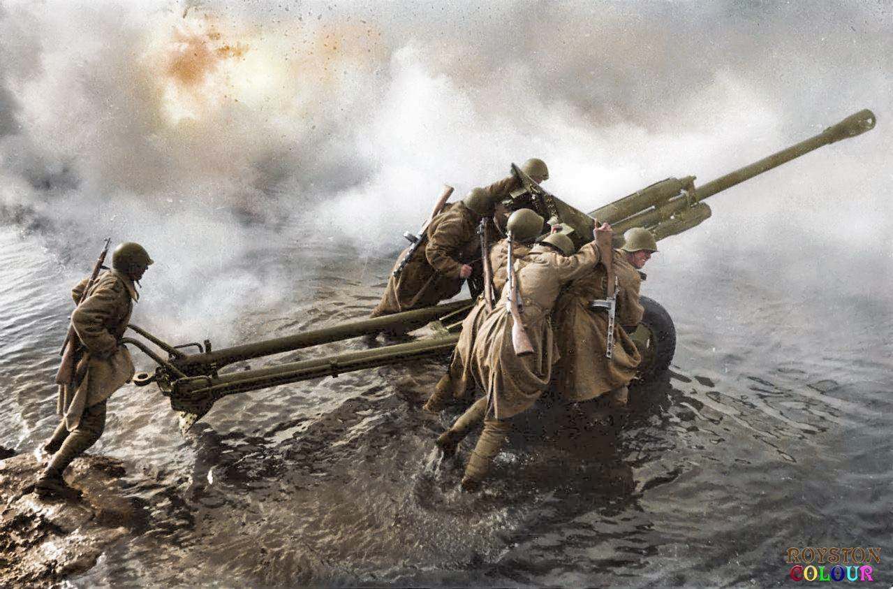 Soviet artillerymen transporting a 76-mm divisional gun M1942 (ZiS-3) during the forced crossing of the Oder River, Germany, c. December, 1944