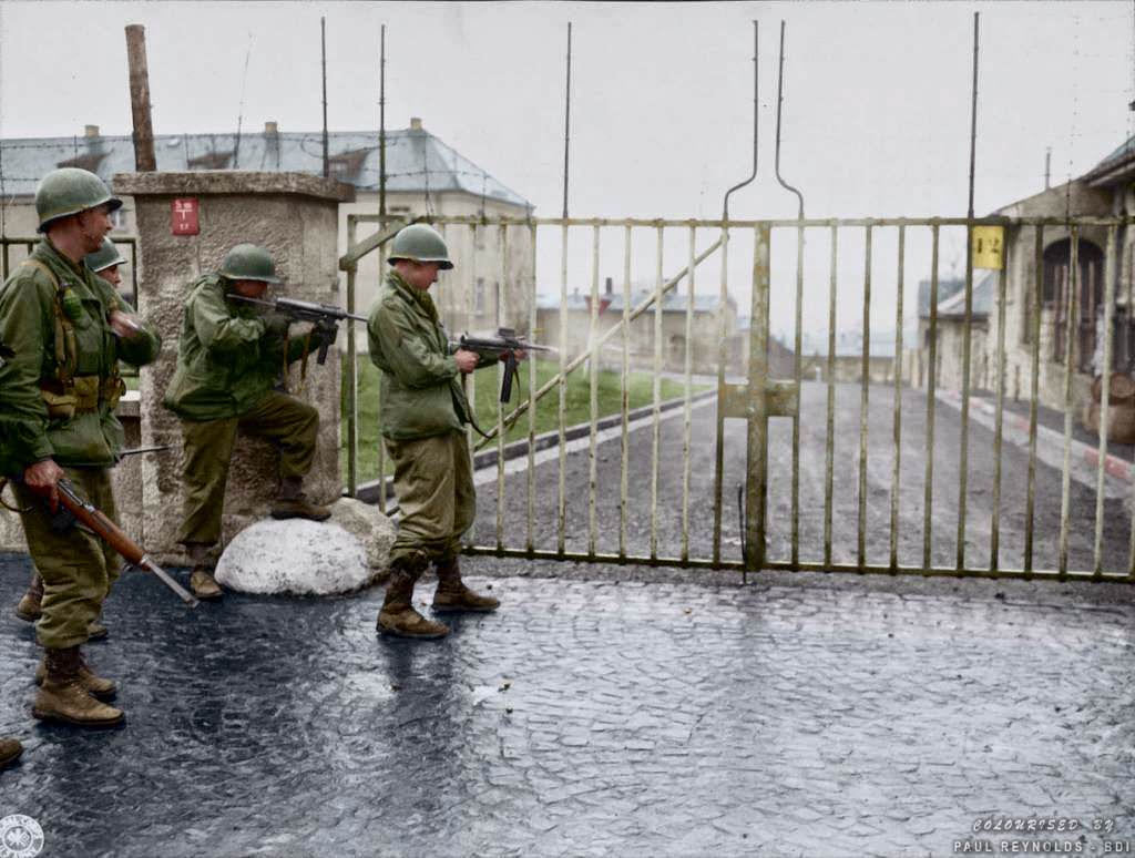 US troops from Combat Command B of the U.S. 14th Armored Division entering the Hammelburg Prison in Germany by opening the main gate with bursts of their M3 "Grease Guns". Hammelburg, Germany. April 6, 1945