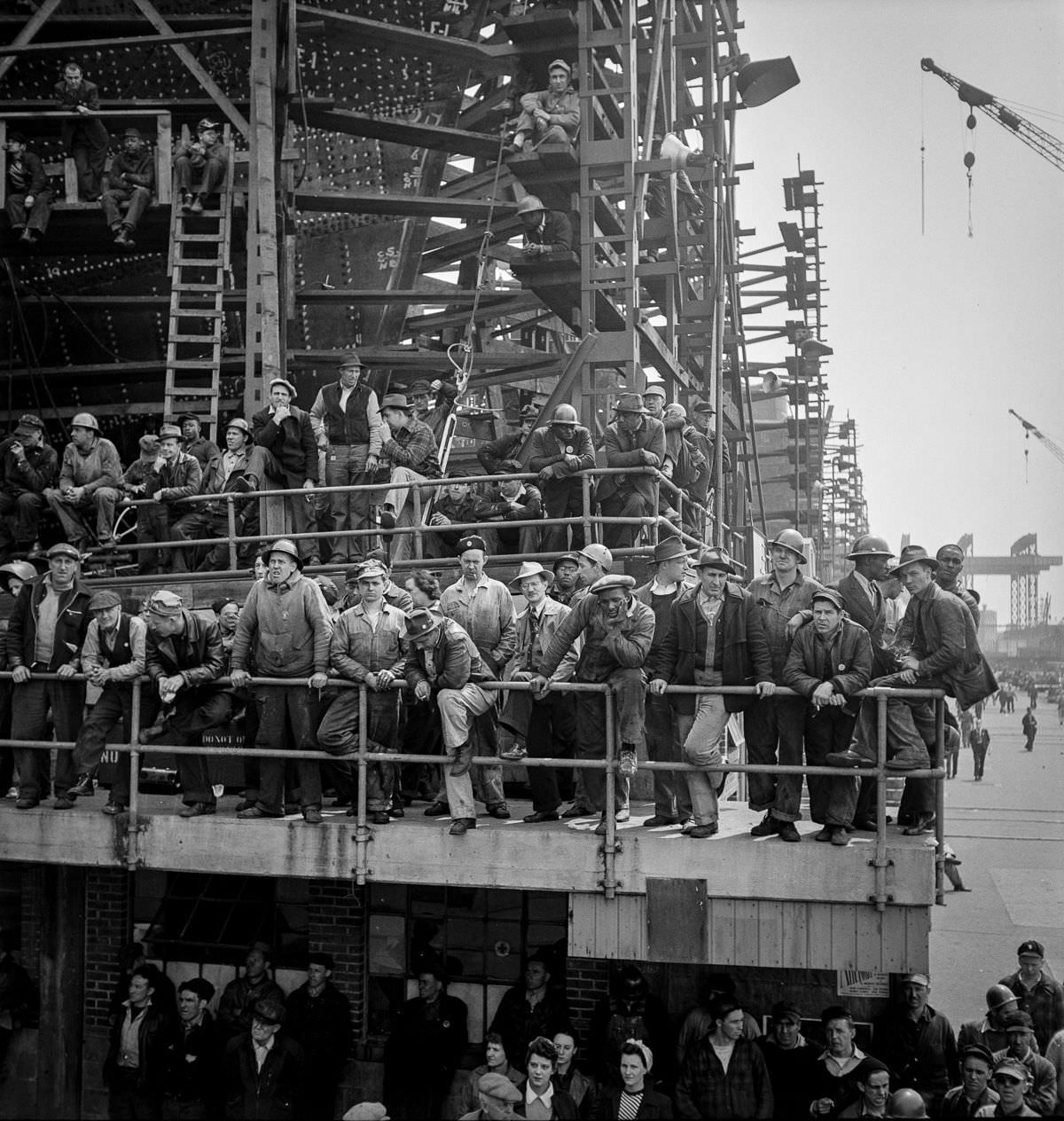 Workers gather to watch a launching ceremony