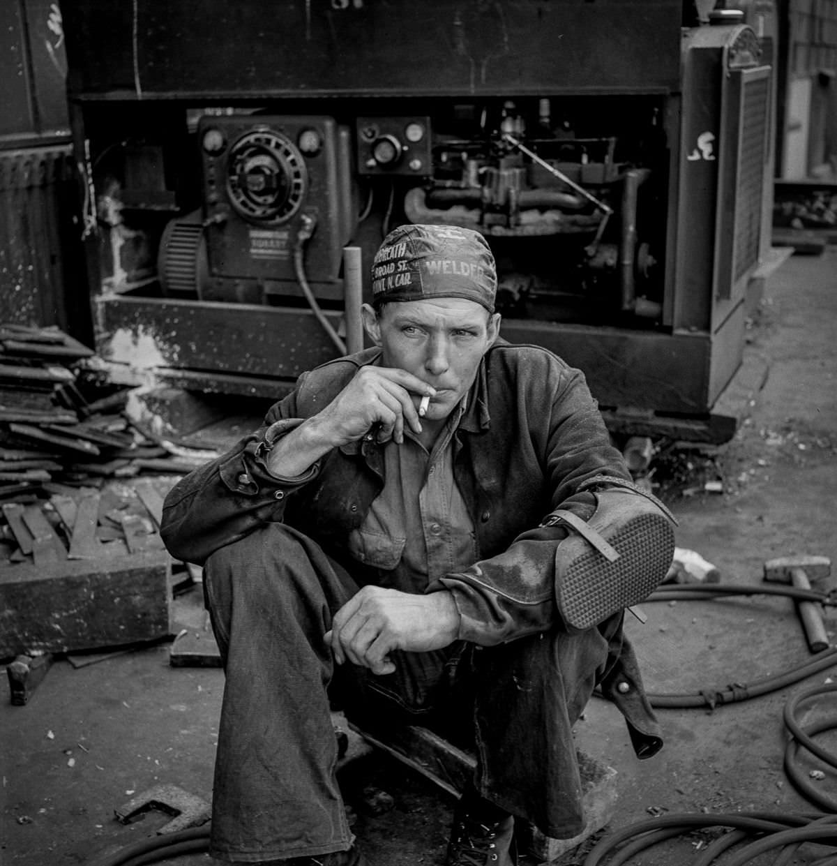 A welder rests during his lunch hour