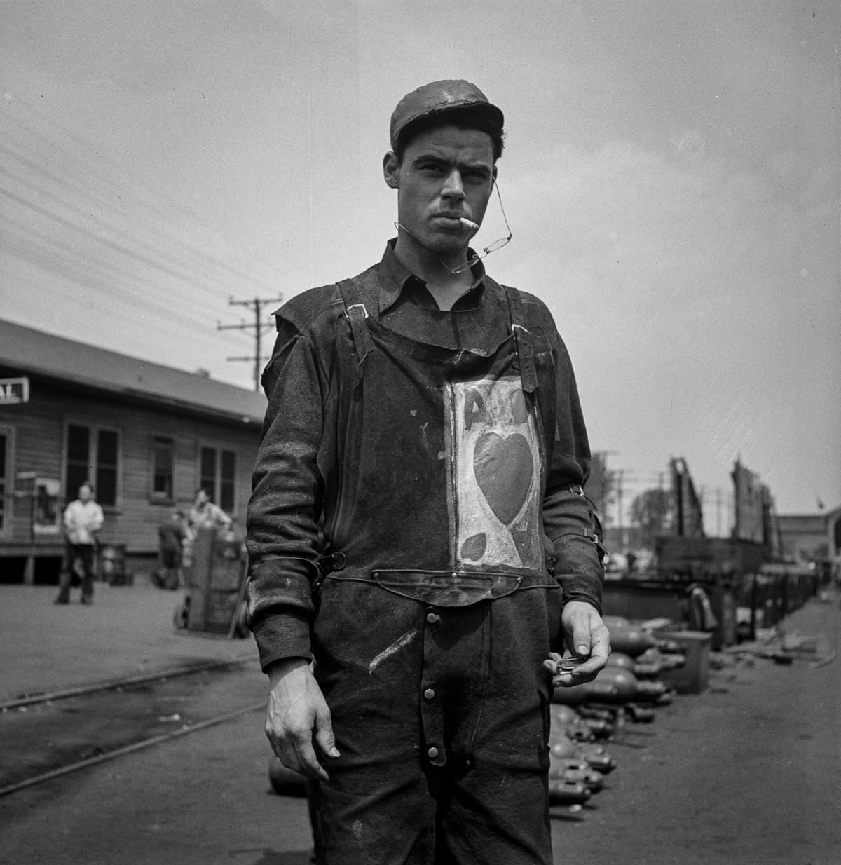 A worker with a personal monogram on his overalls