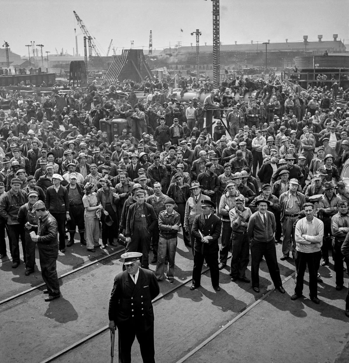 Workers gather for a ship launching ceremony