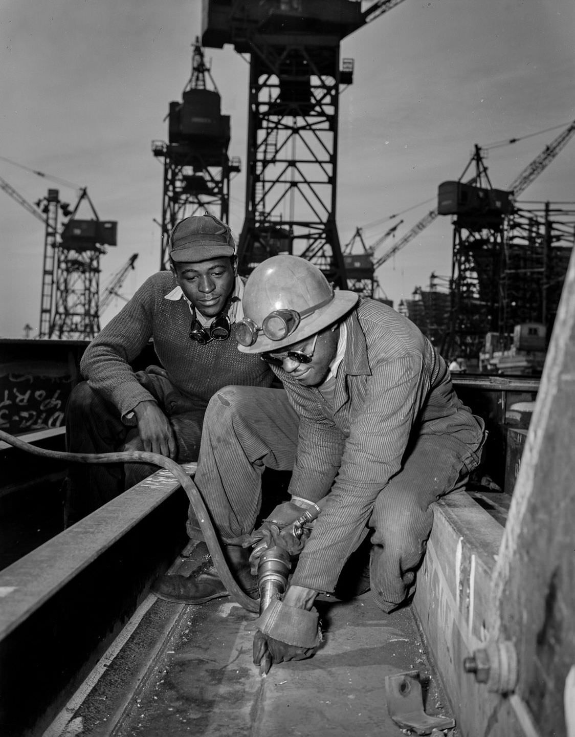 A chipper removes excess metal from a welded seam aboard the Liberty ship Frederick Douglass