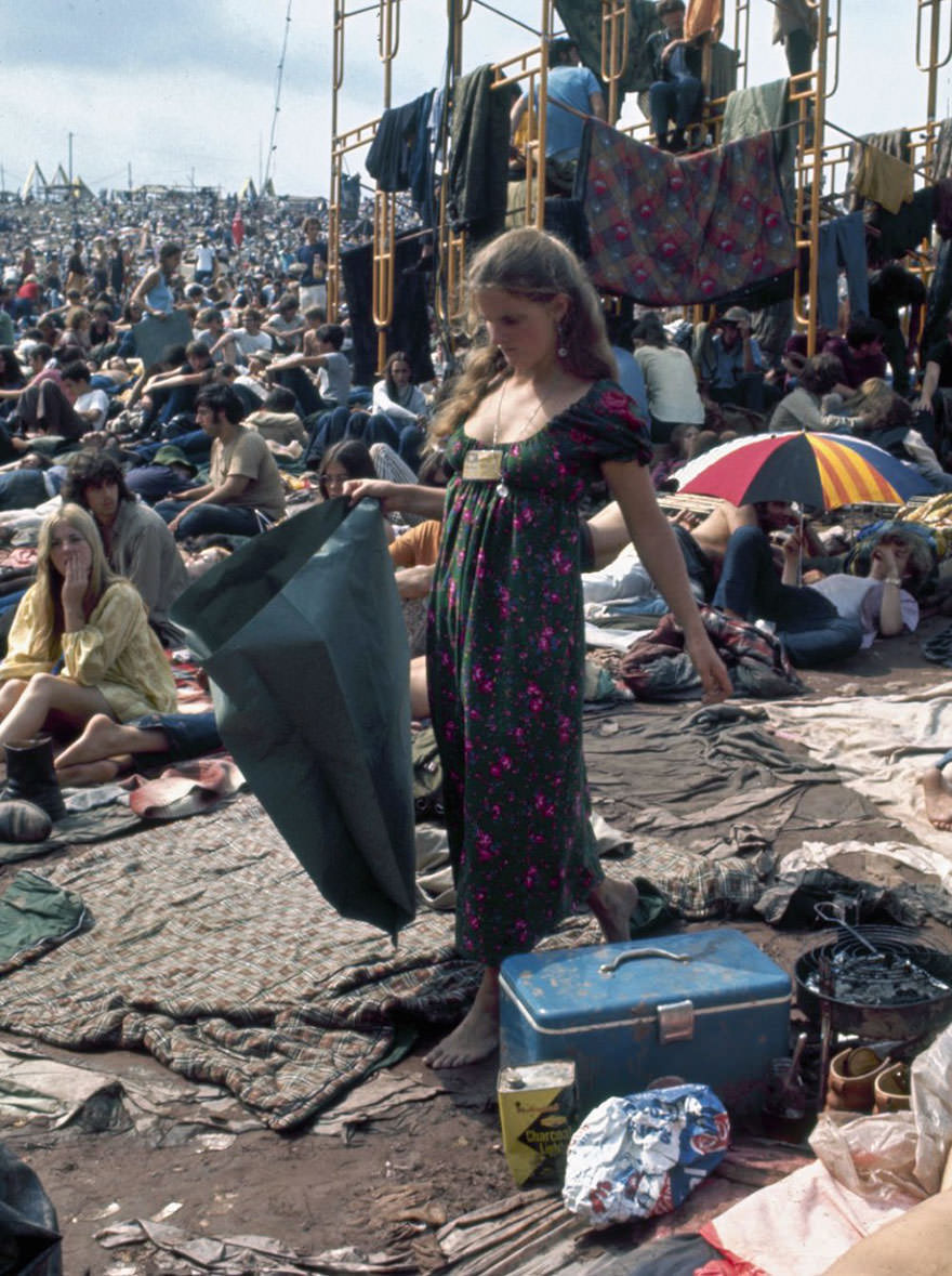 Woman Picks Her Way Barefoot Through Mud And Sleeping Bags