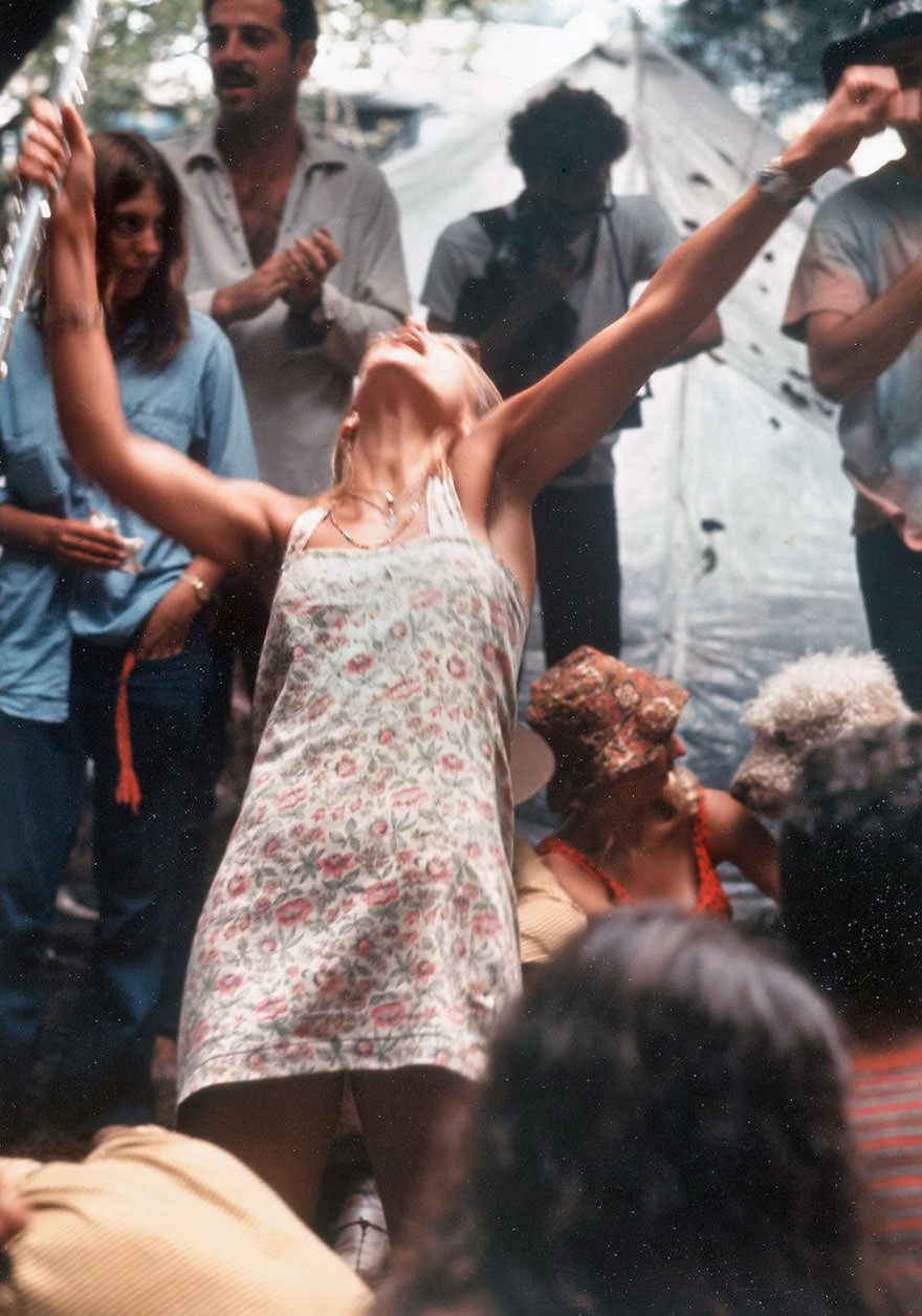 Hippie Girl Enthusiastically Playing Flute And Dancing At Woodstock Music Festival