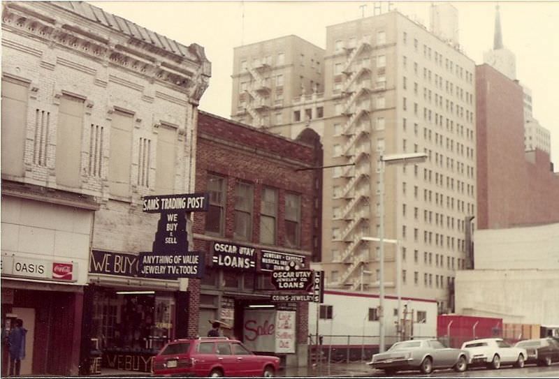 Elm St. just East of Harwood (Oasis Bar, Sam's Trading Post and Oscar Utay Loans), 1982