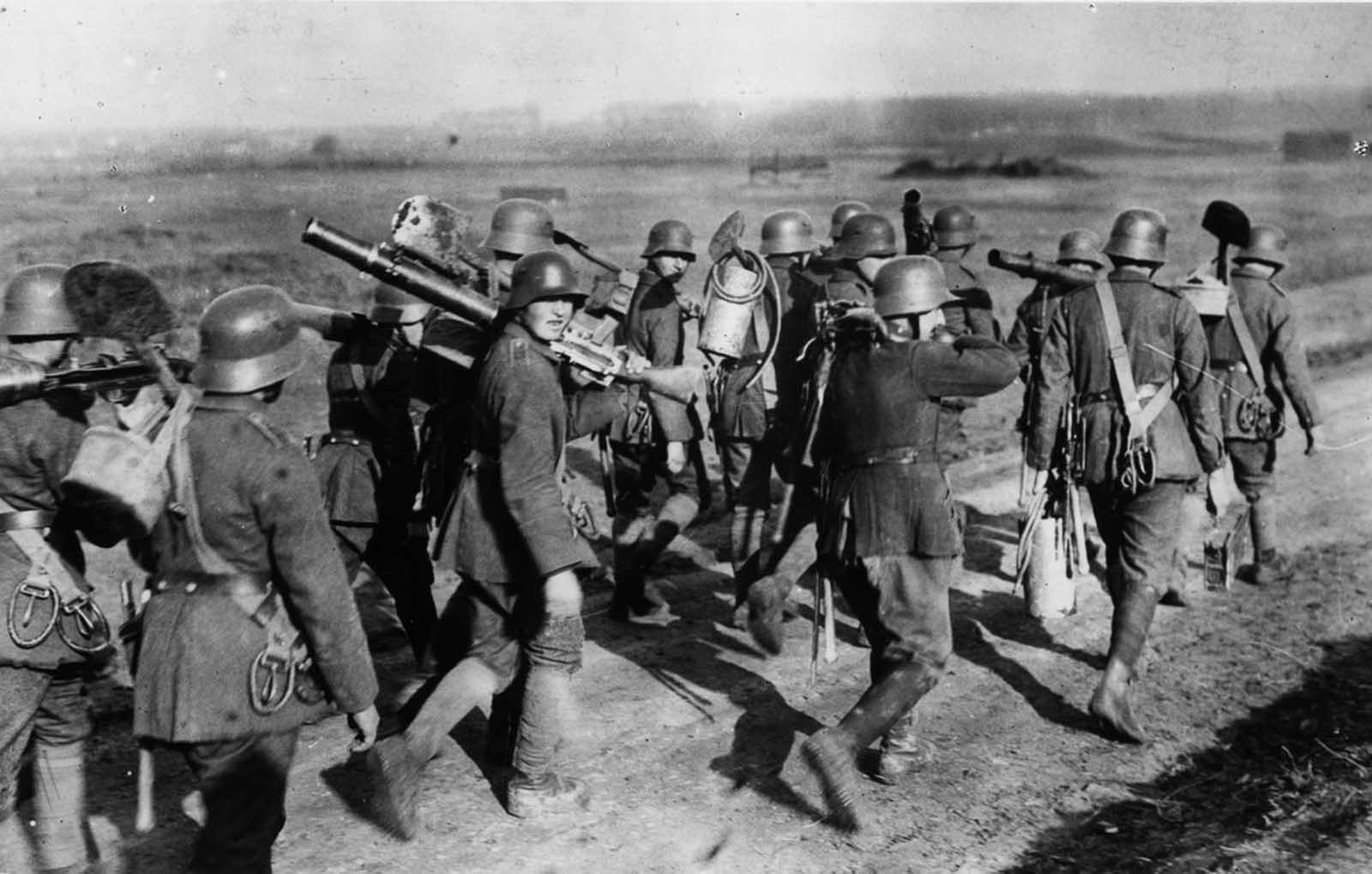 German troops carry Lewis gun equipment.