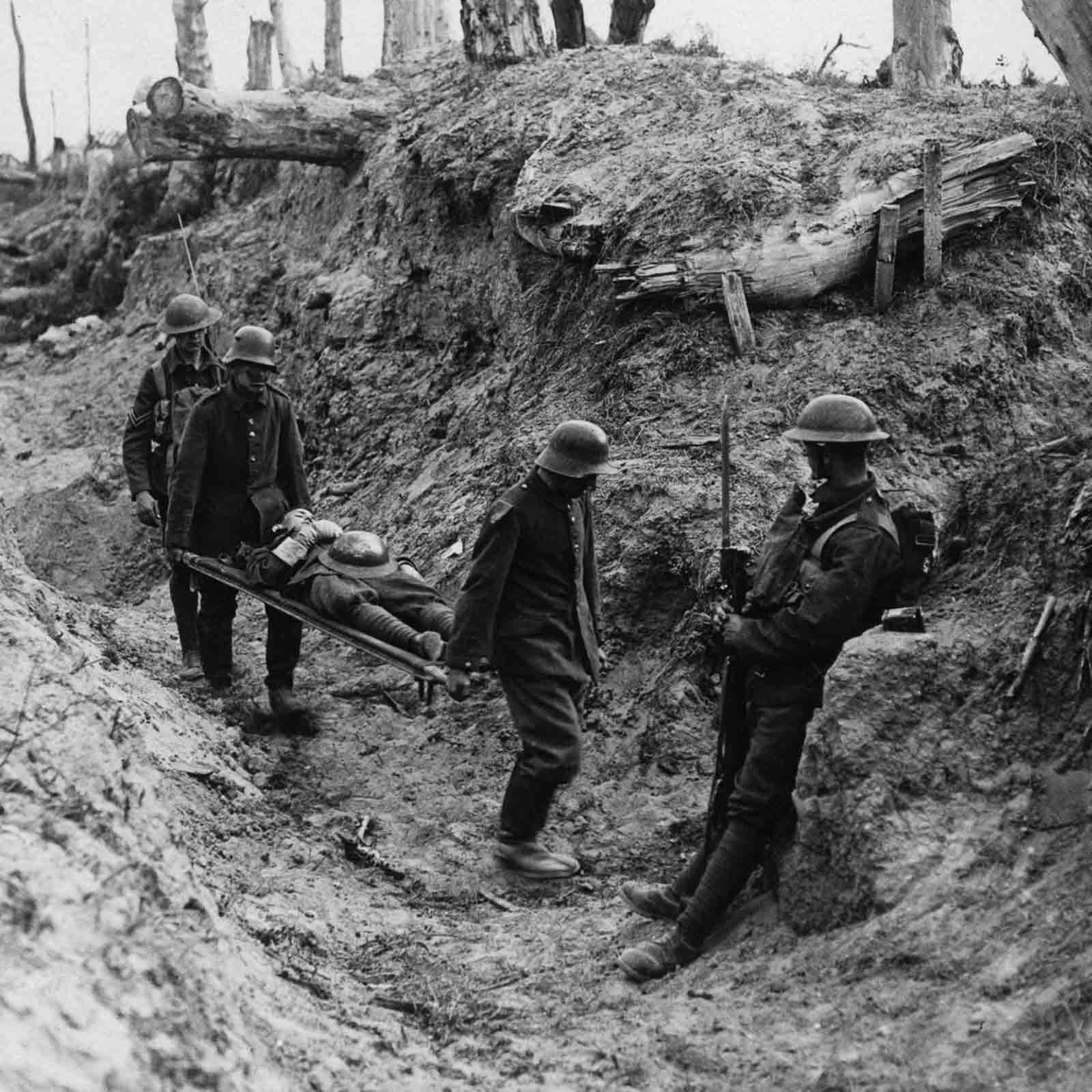 German prisoners carry British wounded during the assault on Trones Wood.