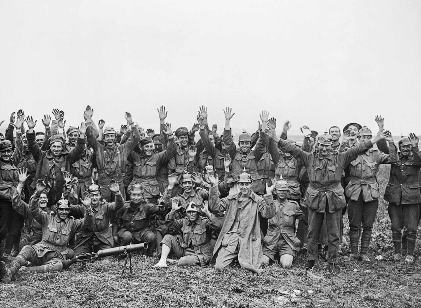 Men of the 1st Anzac Division, some wearing German helmets, pose for the camera after fighting near Pozieres Ridge. July 23, 1916.
