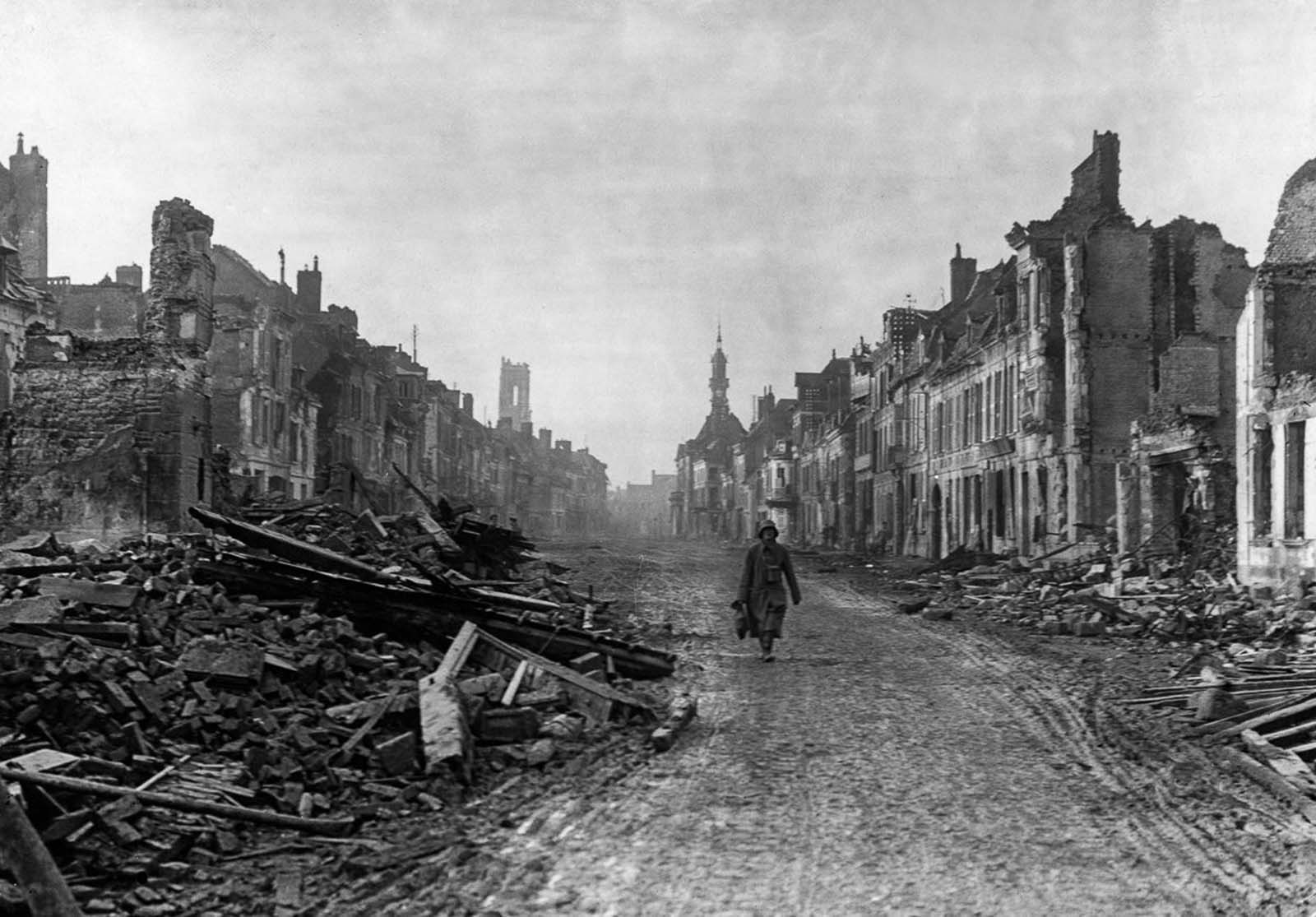 A German soldier walks through the ruined streets of Peronne. November, 1916.