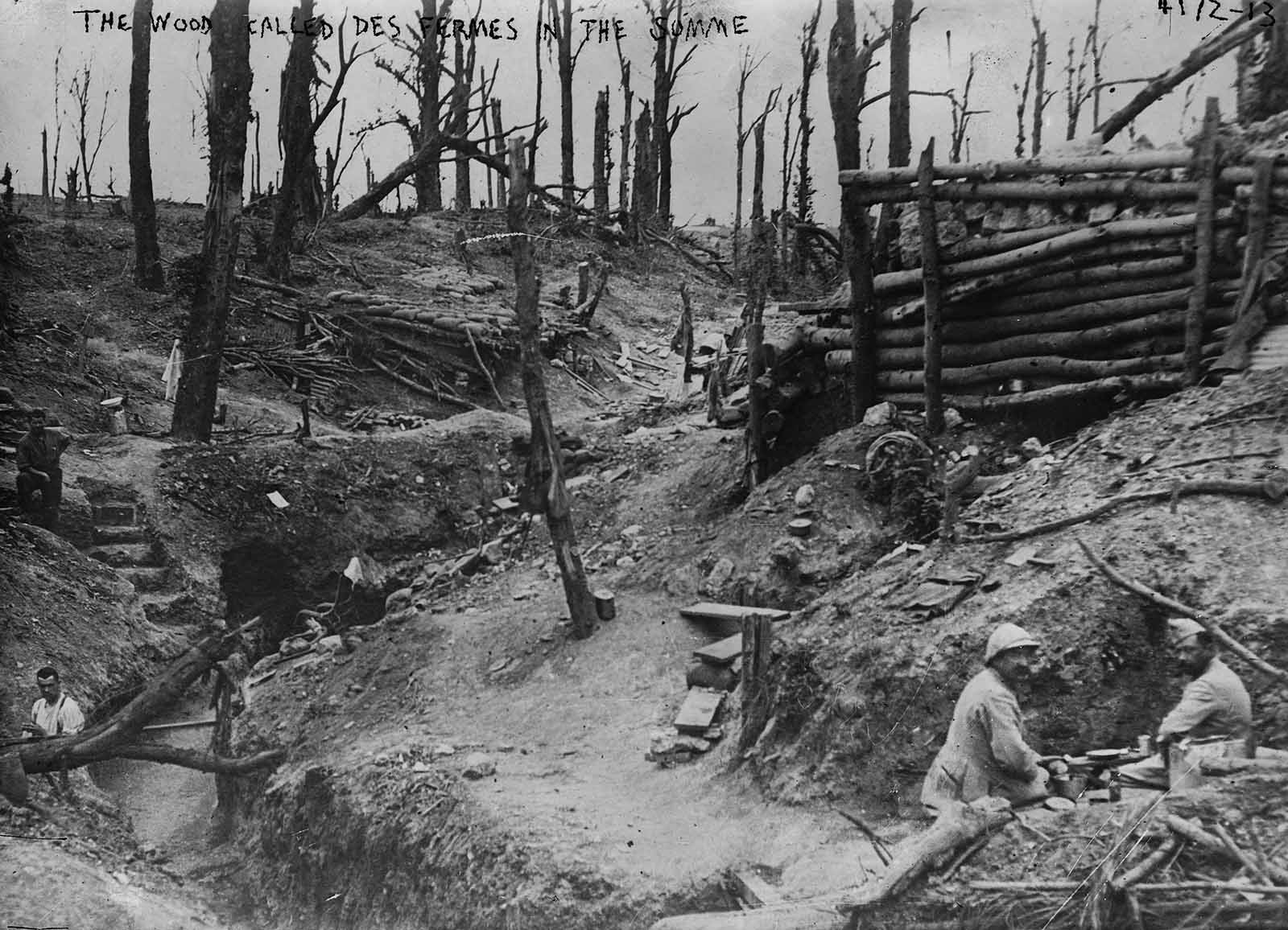 Soldiers sit in the trenches of the wood called Des Fermes in the Somme.