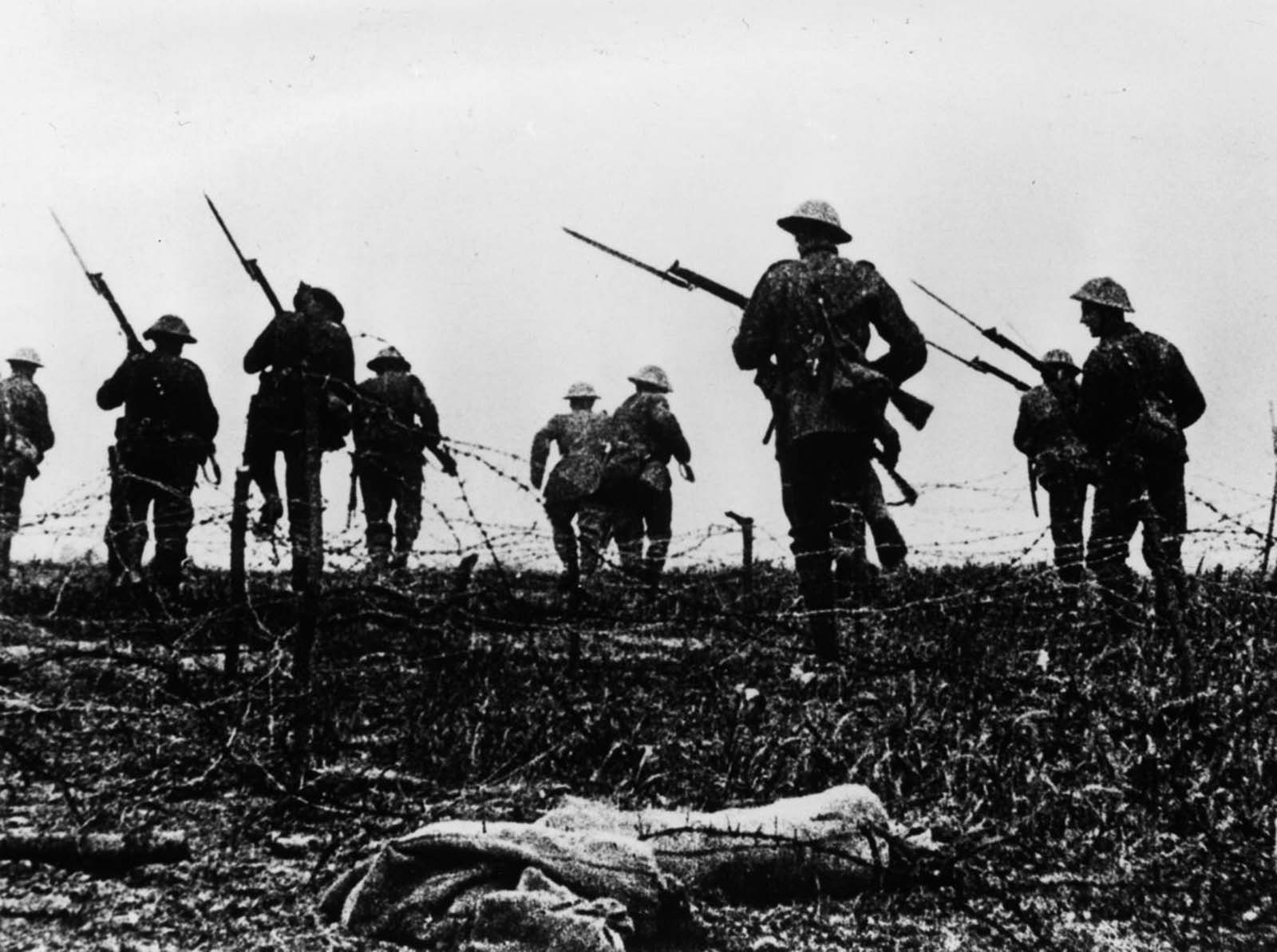 British troops go “over the top” in a scene staged for a newsreel film on the battle. 1916.