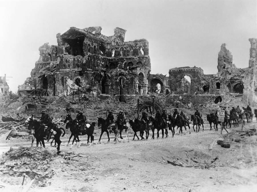 A troop of British cavalry pass the remains of the Albert Cathedral during the second Battle of the Somme.