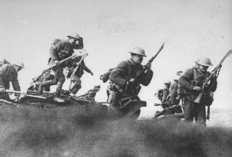 Canadian troops with fixed bayonets leave their trenches for a raid.
