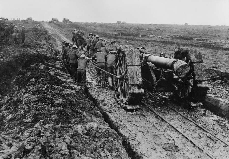 A six-inch howitzer hauled through the mud.