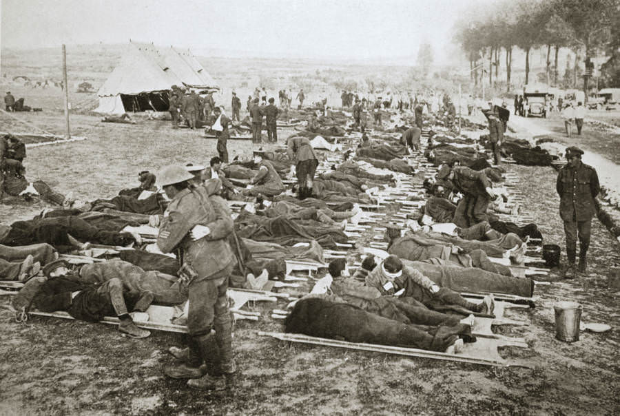 Wounded men wait to be taken away to a clearing station.