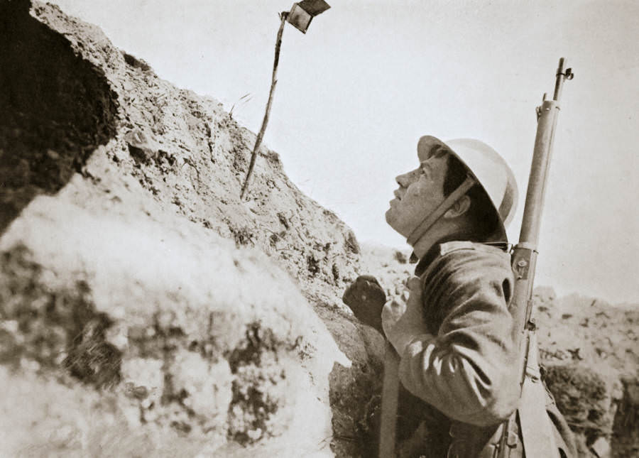 A sentry in the trenches looking through an improvised periscope.