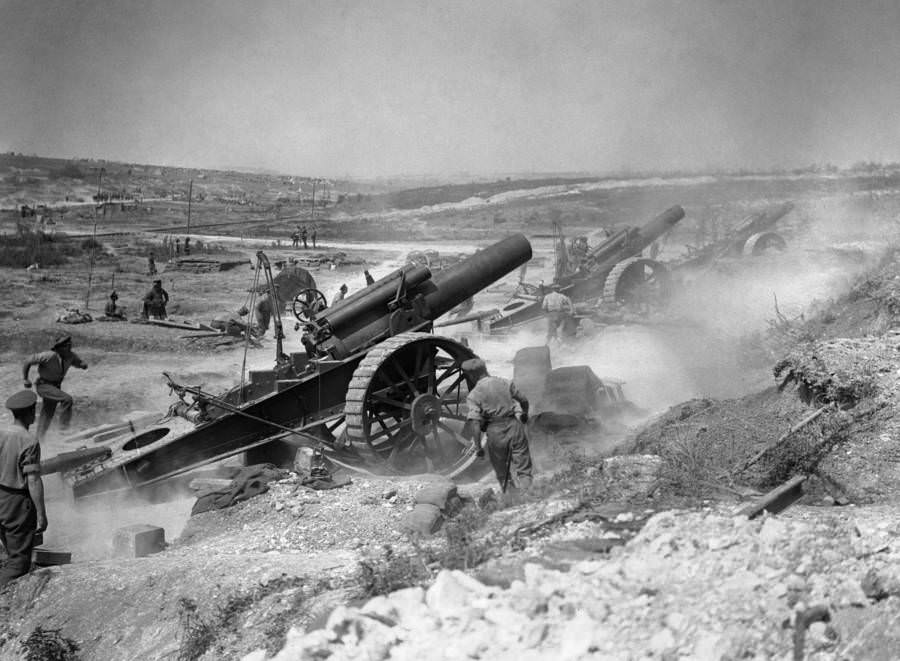 Three eight-inch howitzers fire in battle.