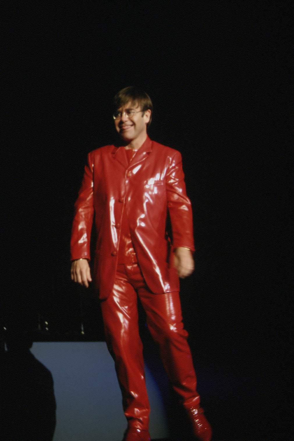 Elton John in a red leather suit for a show in Paris, 1994.