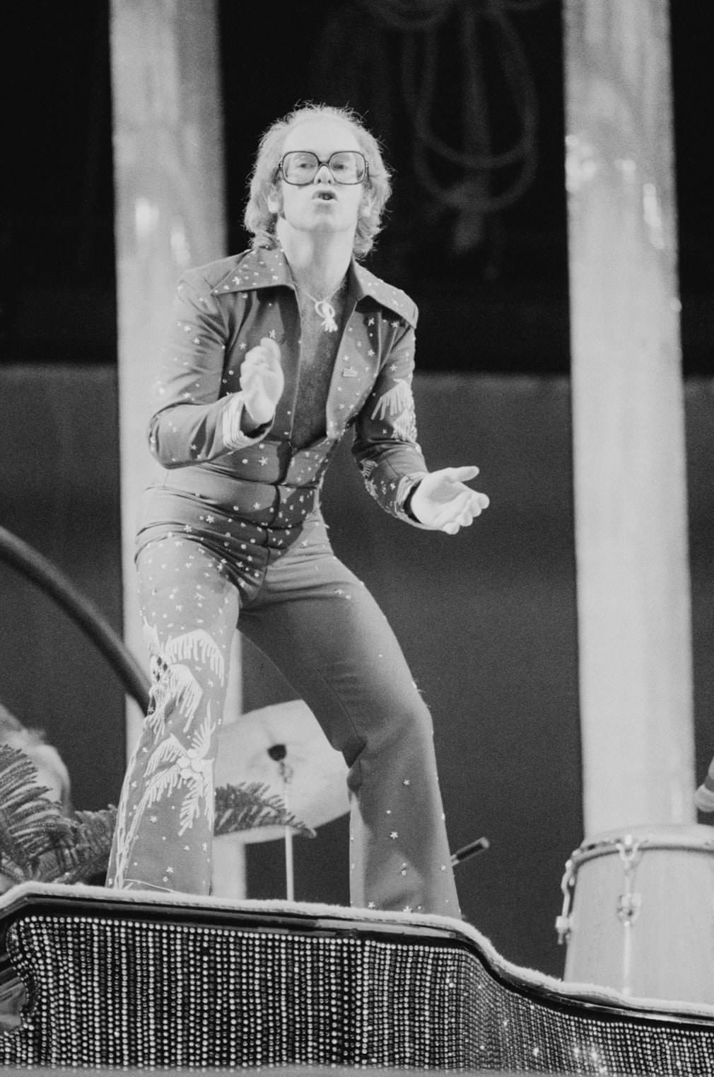 Elton John, 1975 wearing a jumpsuit at London