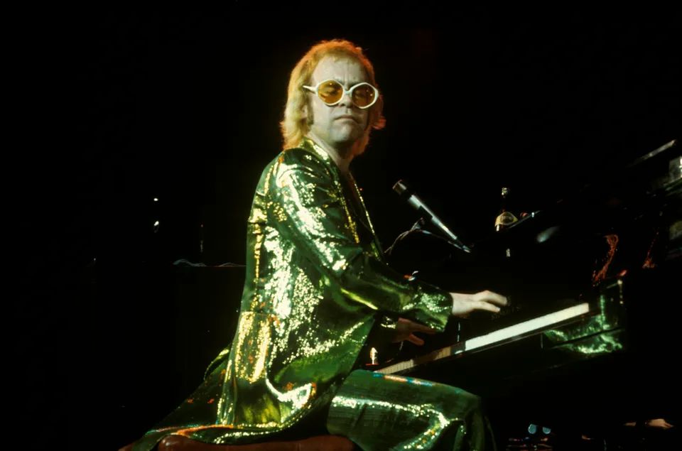 Elton John onstage in a sequined suit, 1973