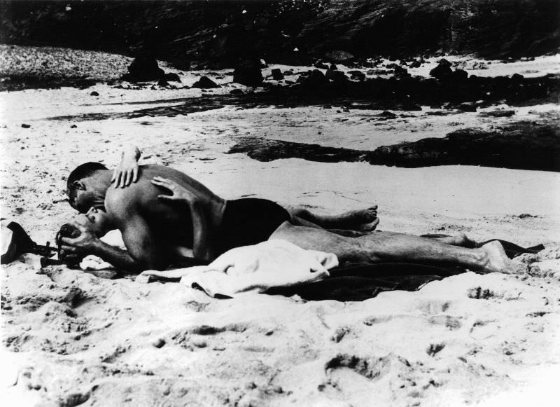 Burt Lancaster and Deborah Kerr kiss on the beach in a scene from the film 'From Here to Eternity', 1953.