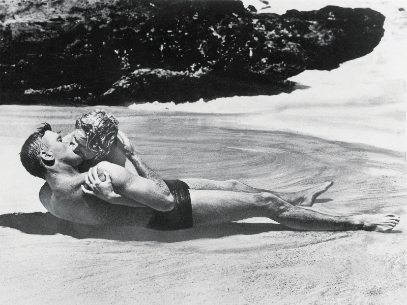 Burt Lancaster and Deborah Kerr passionately kissing in a scene from 'From Here to Eternity,' Halona Cove, Oahu, Hawaii, 1953.