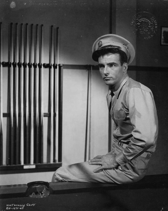 Montgomery Clift sits on a pool table in a scene from the film 'From Here to Eternity,' 1953.