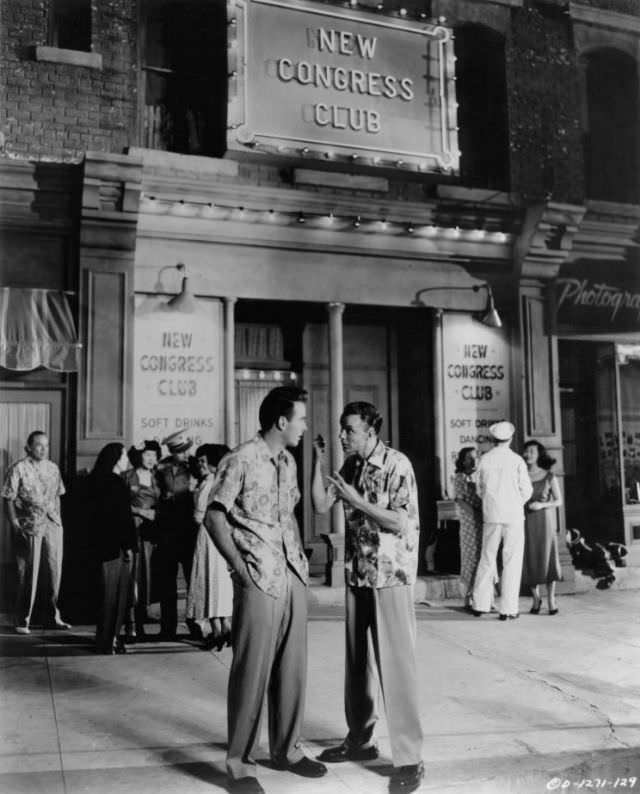 Montgomery Clift talks to Frank Sinatra watches in a scene from the film 'From Here to Eternity,' 1953.