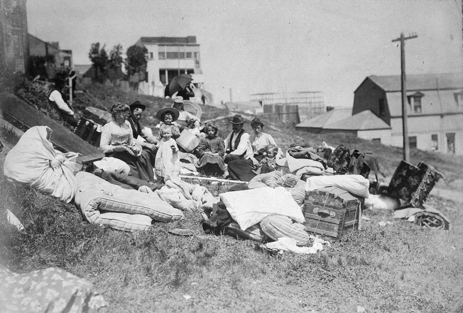 Refugees from the disaster rest on a hillside.