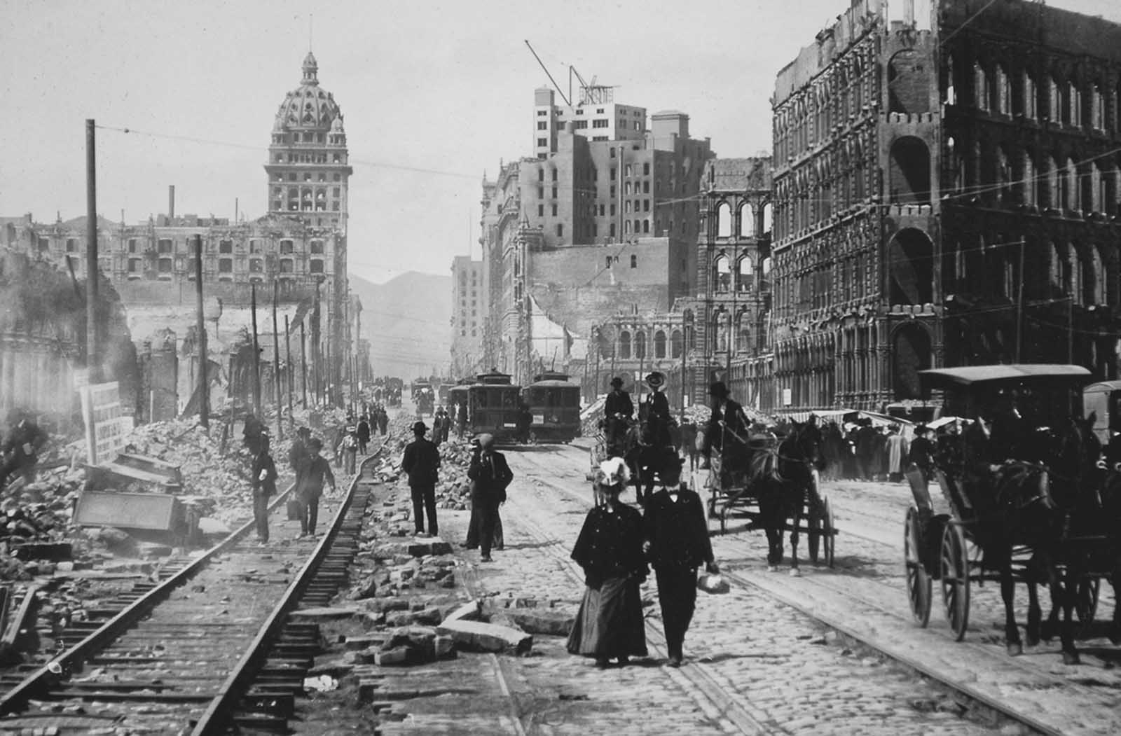 Market Street, looking west toward the Twin Peaks, from Battery Street. Both sides of Market Street lined with ruined buildings from Battery to Powell.