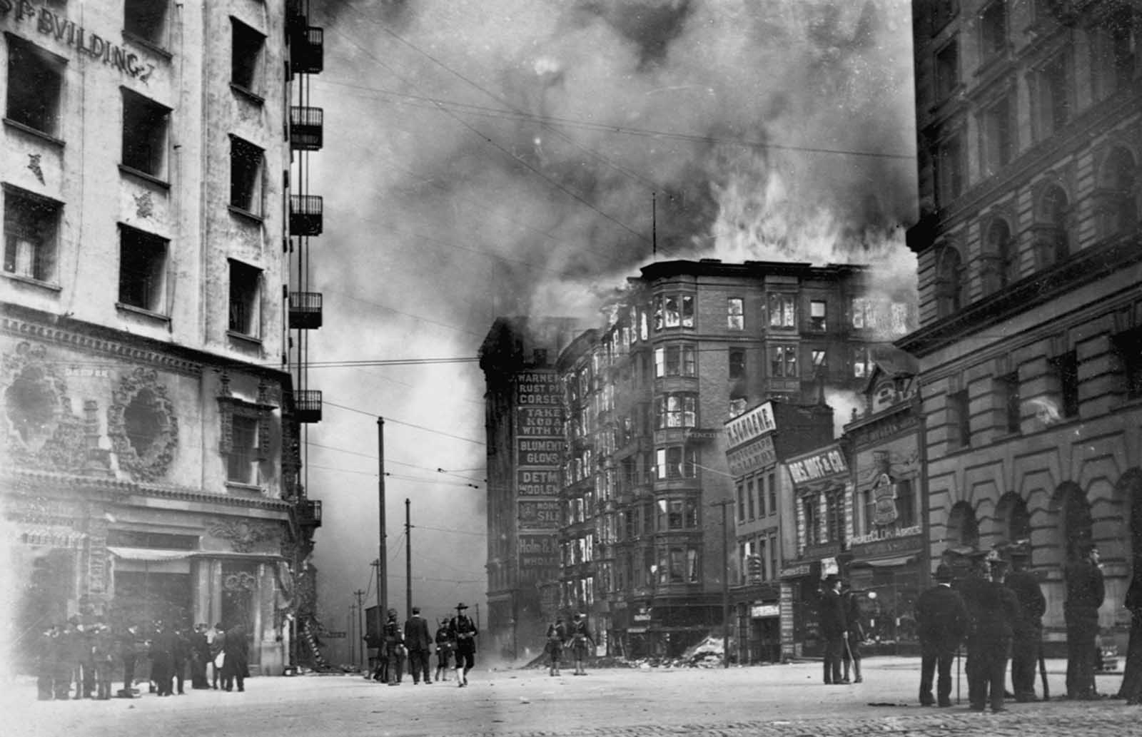 People watch as the Winchester Hotel burns in the aftermath of the 1906 San Francisco earthquake.