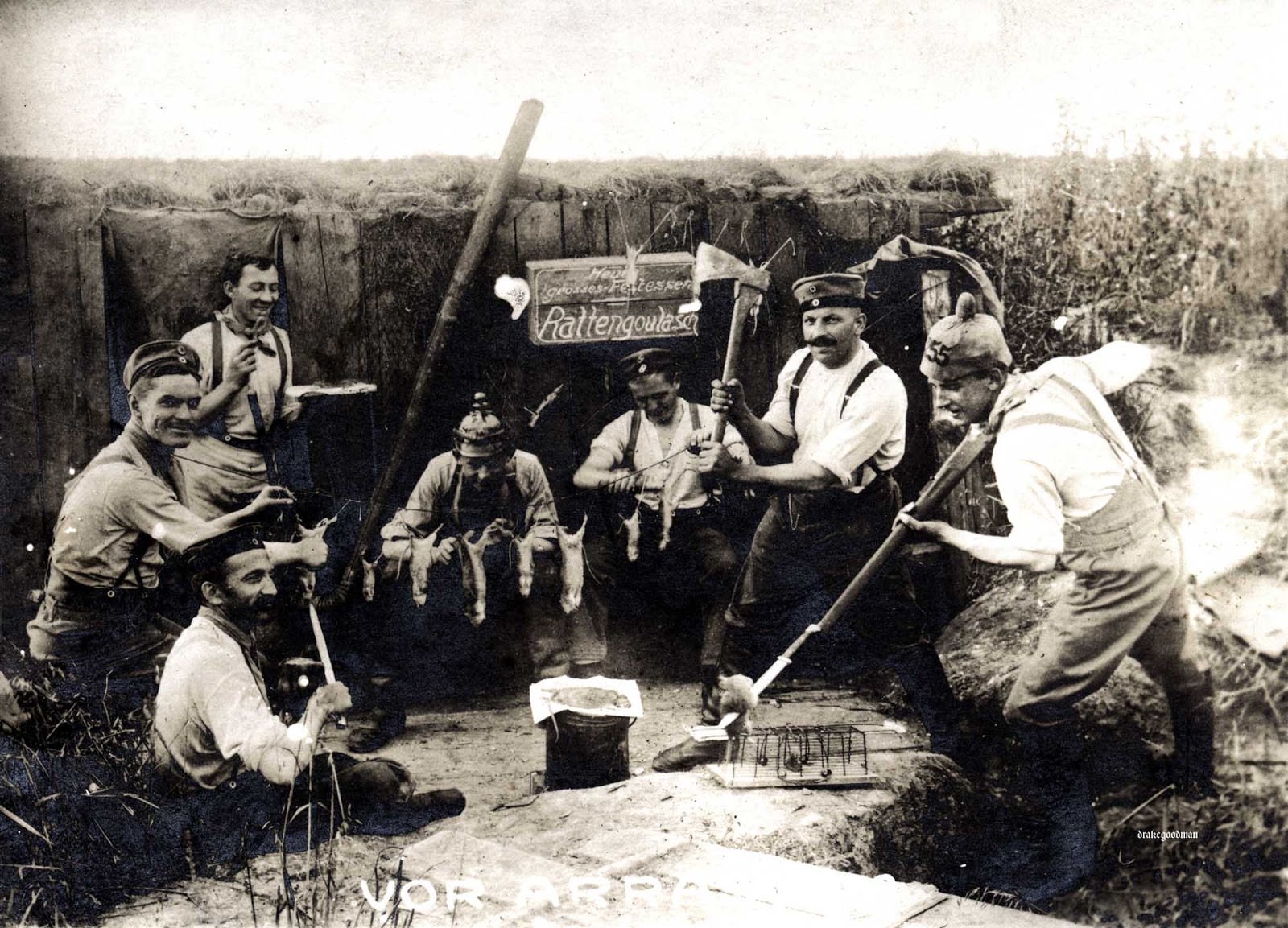 German artillerymen preparing several dead rats and one hapless mouse (or a skittish rat) for their evening repast.