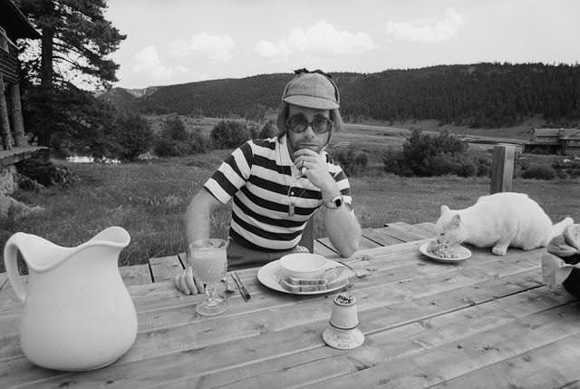 Elton John dining with his cat. Colorado,1974