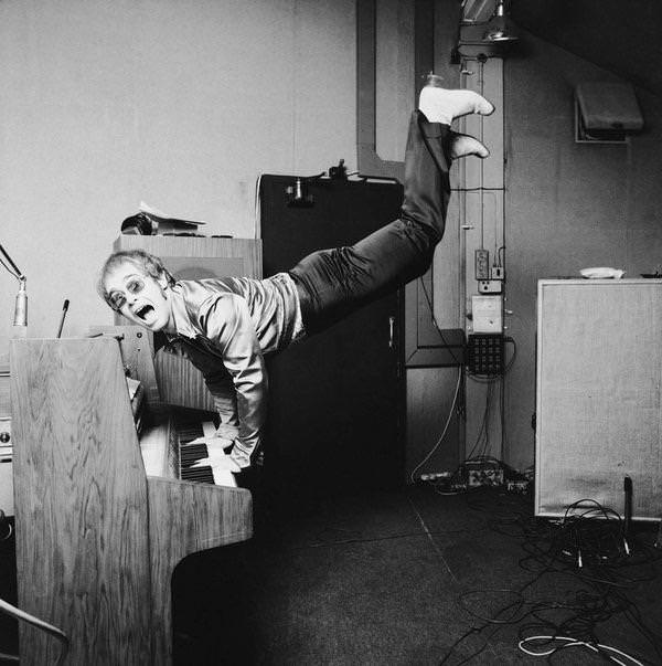 Elton John does a handstand on his piano, London, 1972