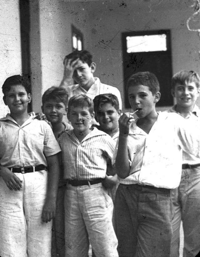 The young Fidel Castro eating a lollipop with his schoolmates at Nuestra Senora de Dolores school in Santiago, Cuba, 1940.