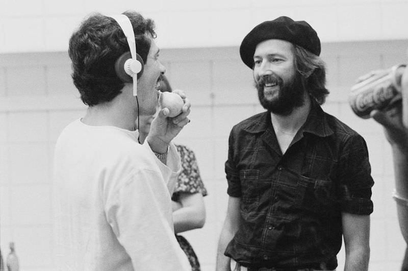 Eric Clapton speaks with his support staff while on tour in the United States in 1975