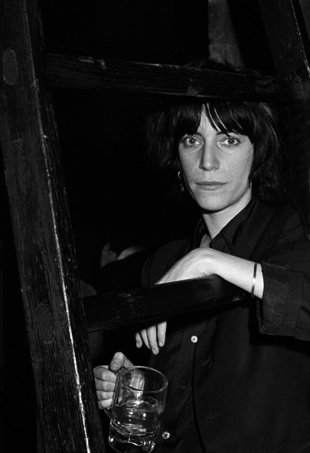 Patti Smith posed backstage before performing with the Patti Smith Group at CBGB's club in New York City on April 4, 1975