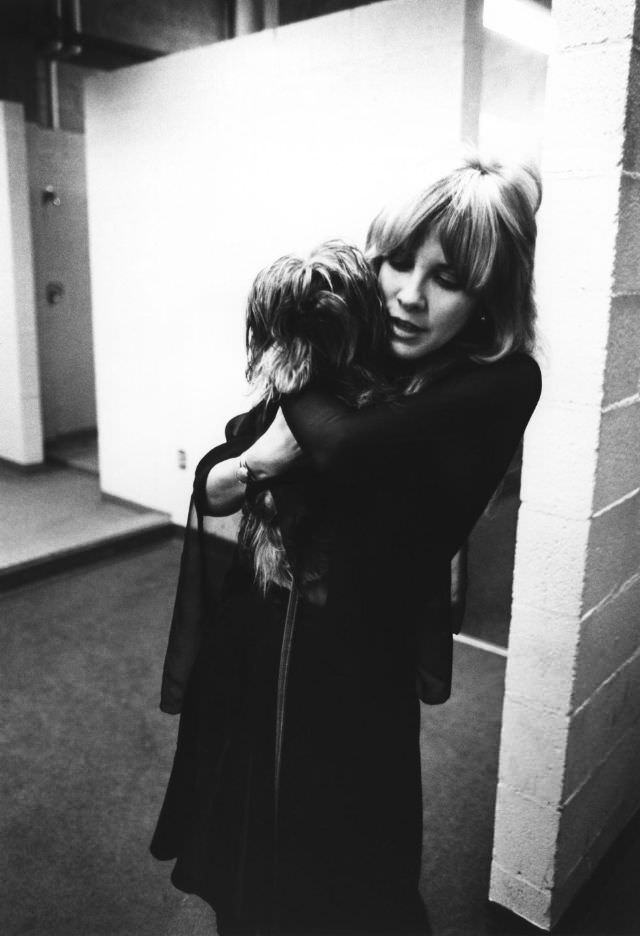 Stevie Nicks of Fleetwood Mac poses backstage in New Haven holding her dog on October 1, 1975